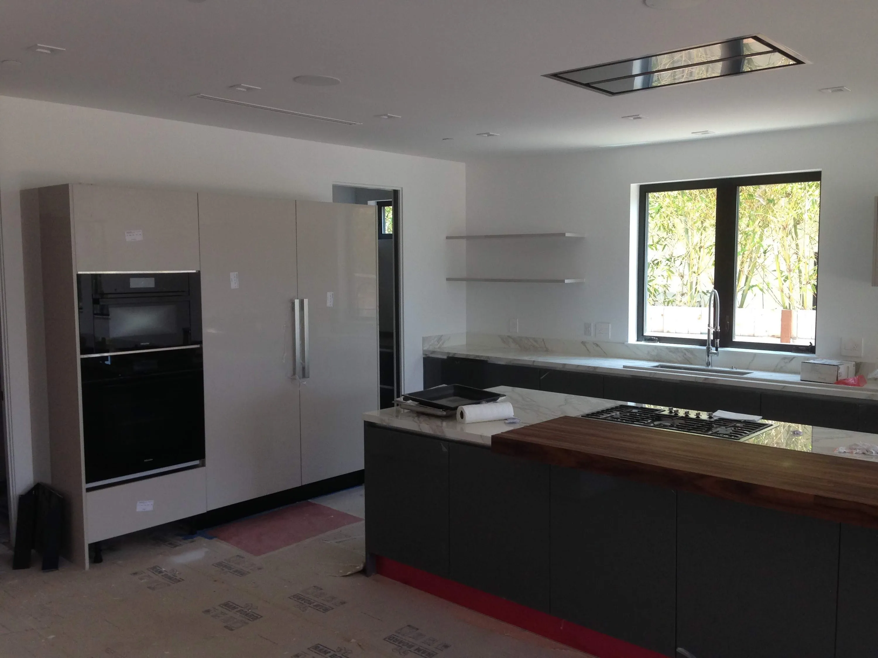 Dark island with wood top during installation