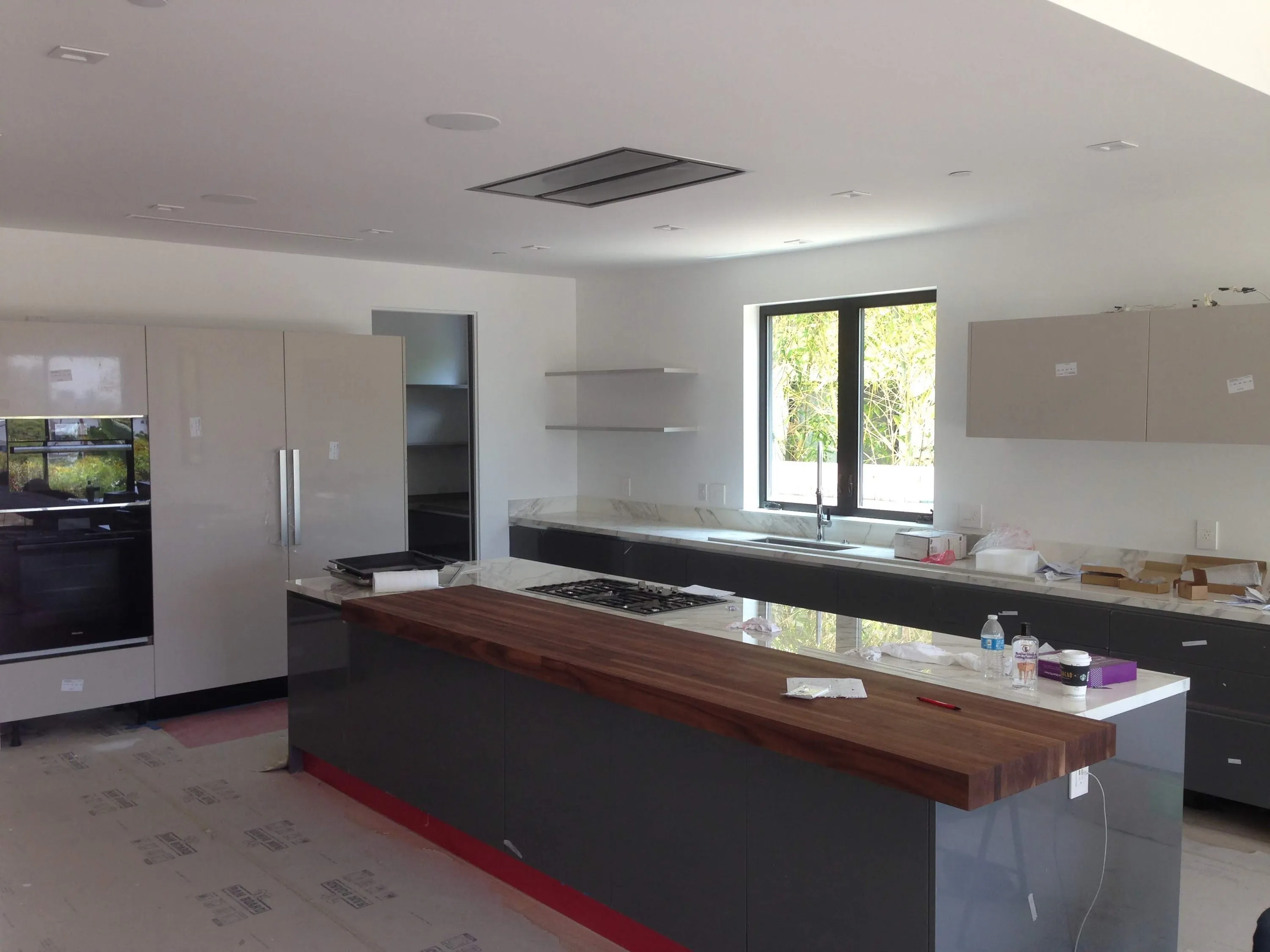 Kitchen with tall appliance wall during installation