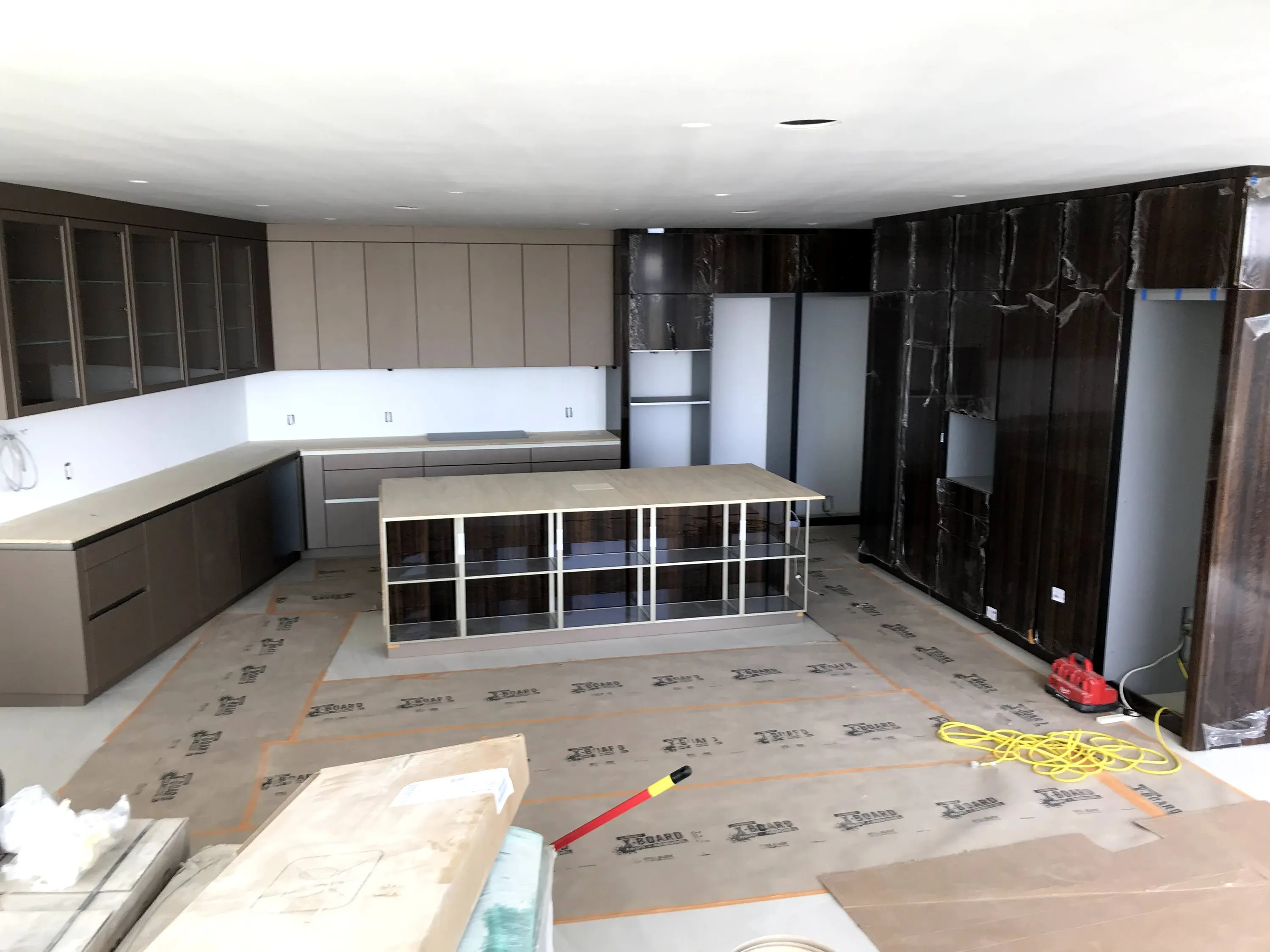 Island frame and stone-clad tall cabinets during installation