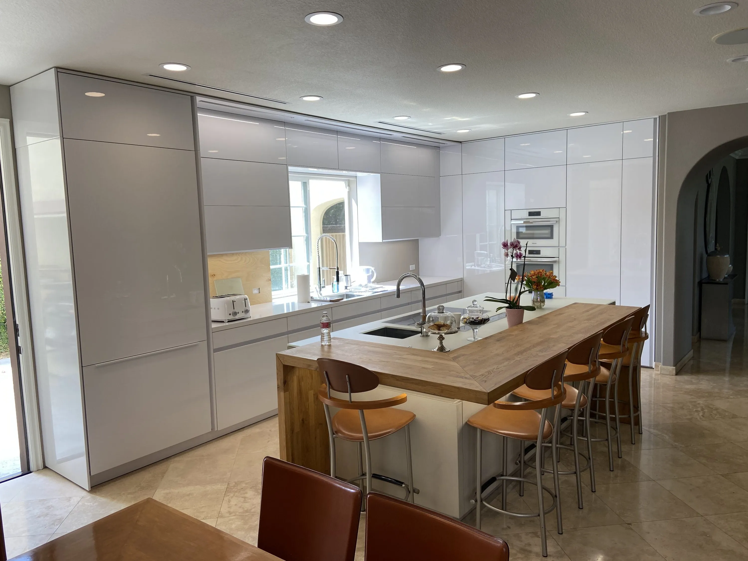 Kitchen with wood bar top and bar stools