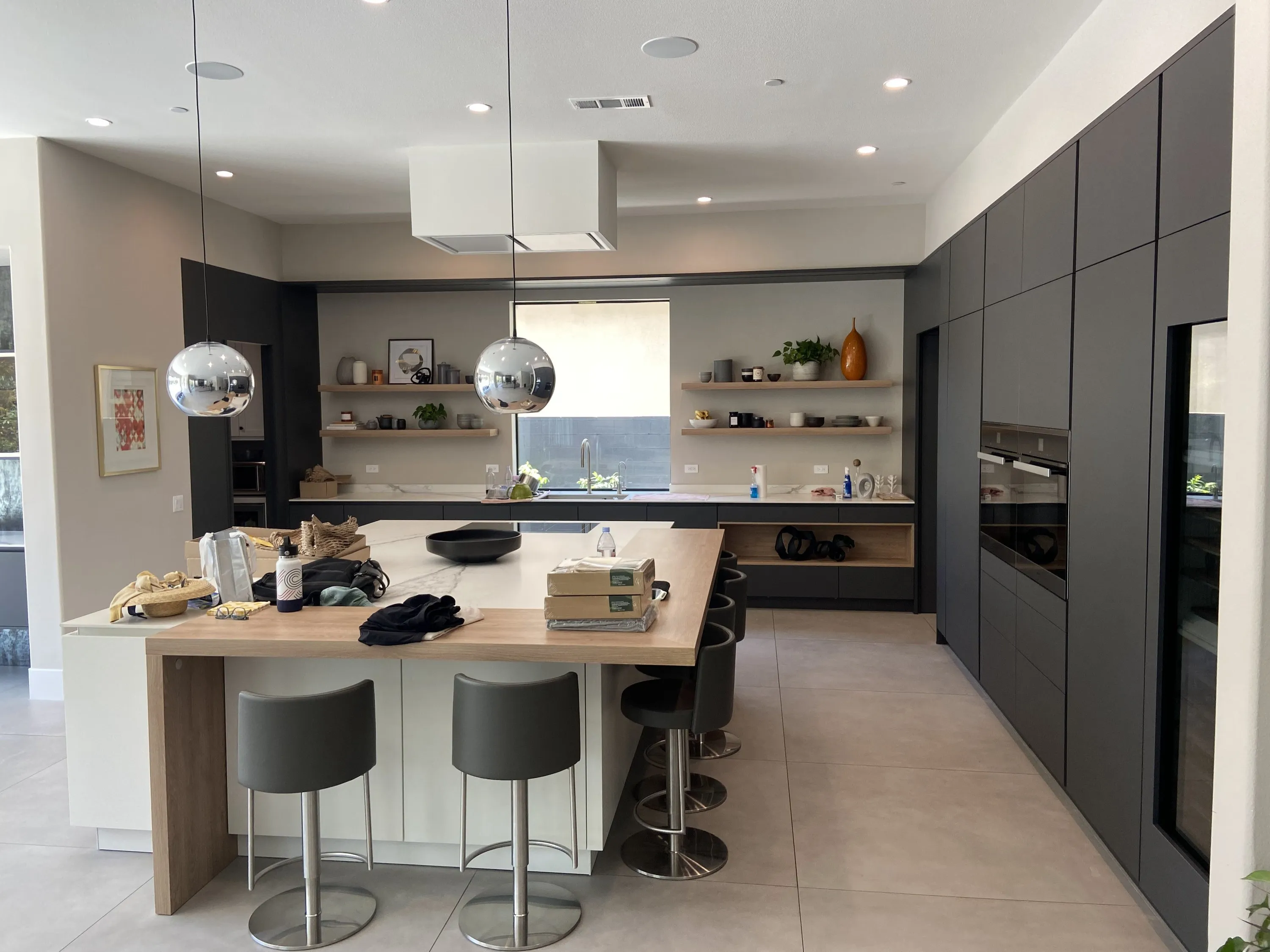 Chef's kitchen with dark tall cabinetry