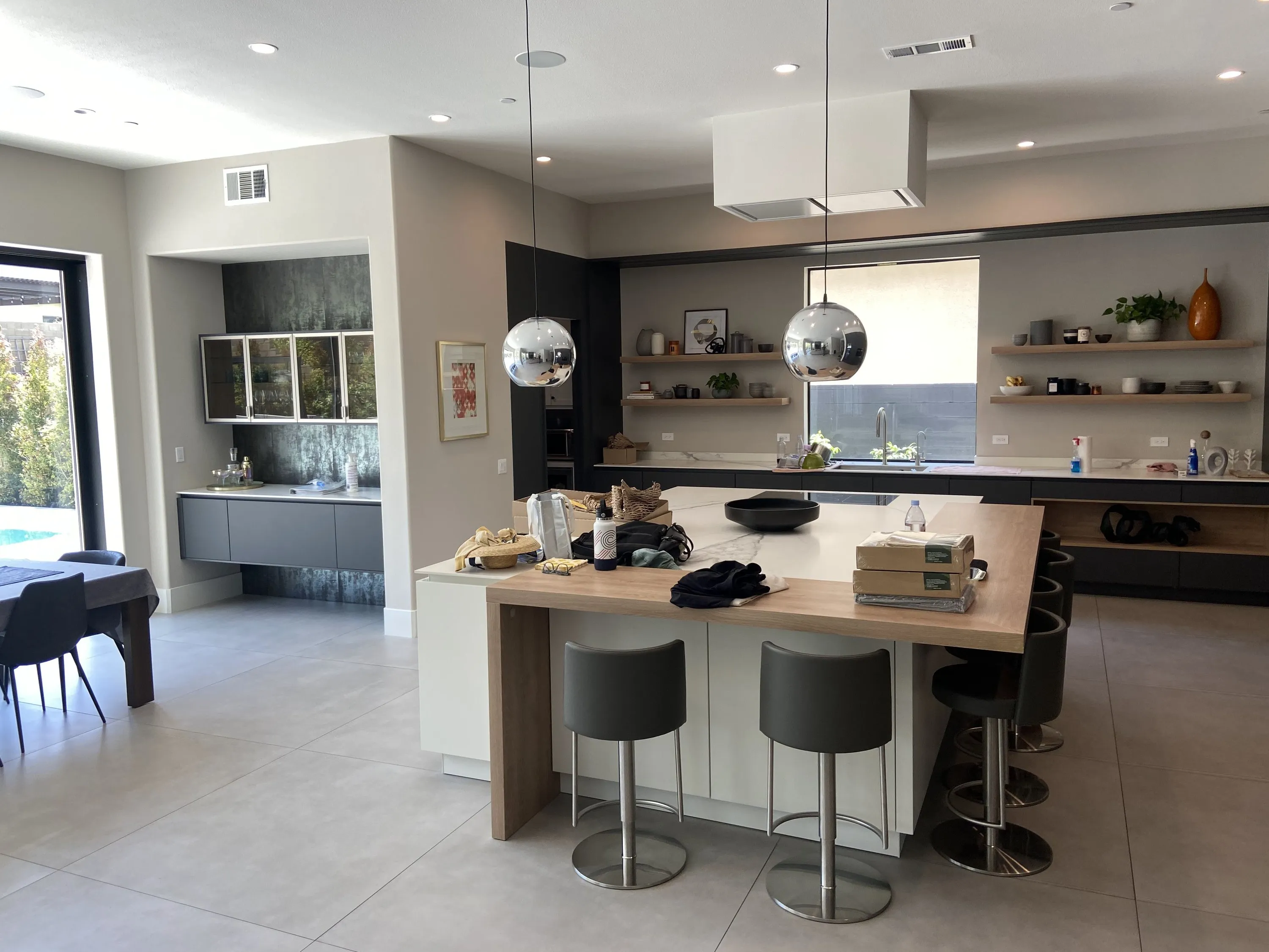 Two-tone island with wood bar and pendant lights