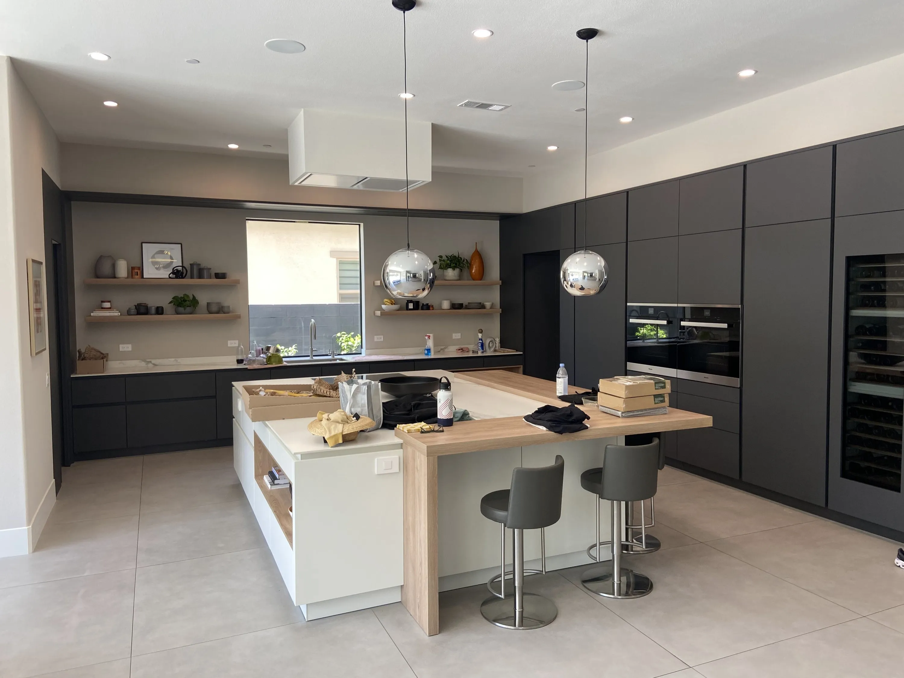 Island with oak bar top and dark cabinet wall